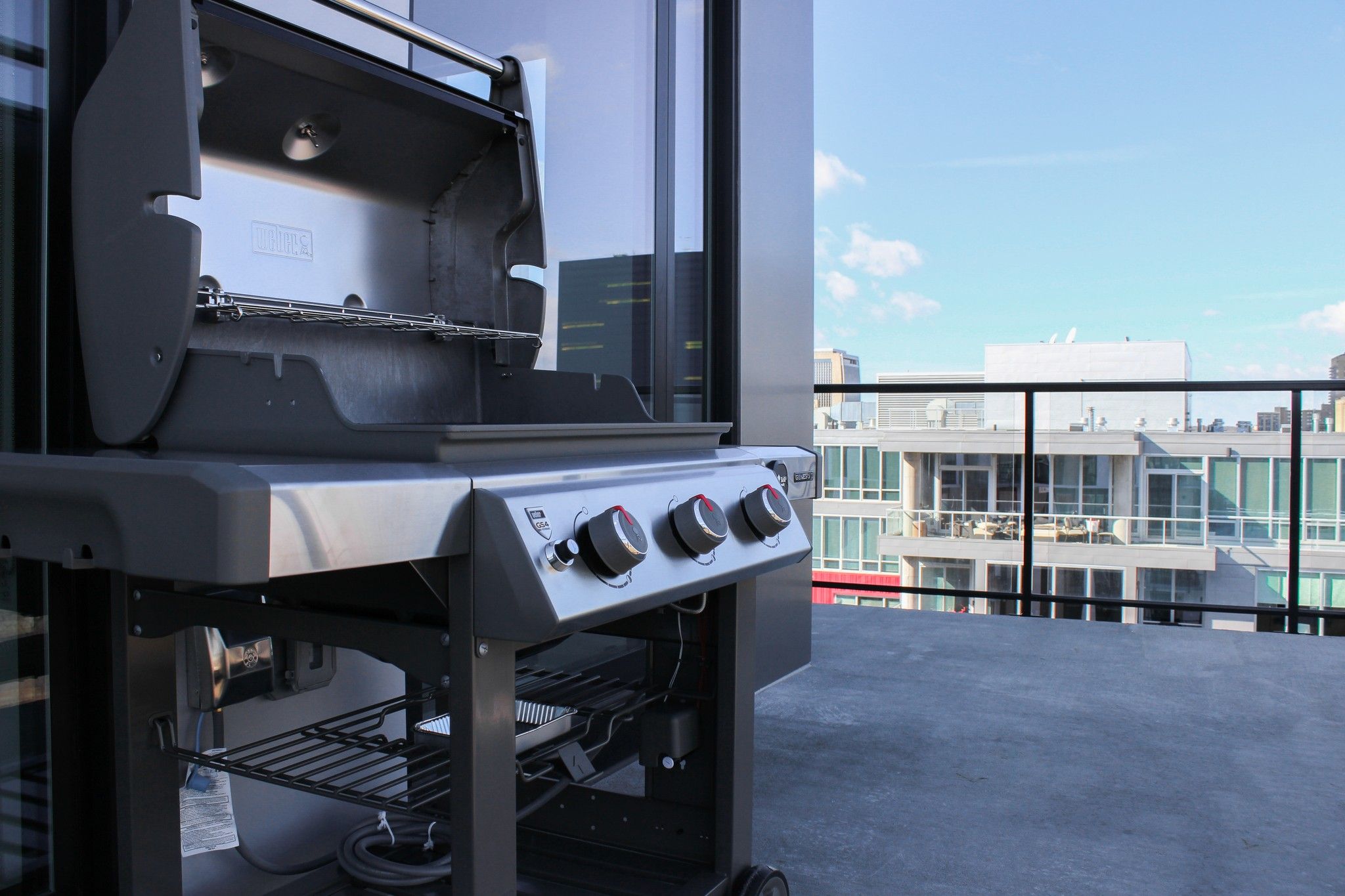Open top Weber® gas grill on a balcony